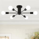Modern black ceiling light fixture with multiple white bulbs in a room.